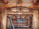 Log home interior :- Log work detail showing massive log floor joists and posts.